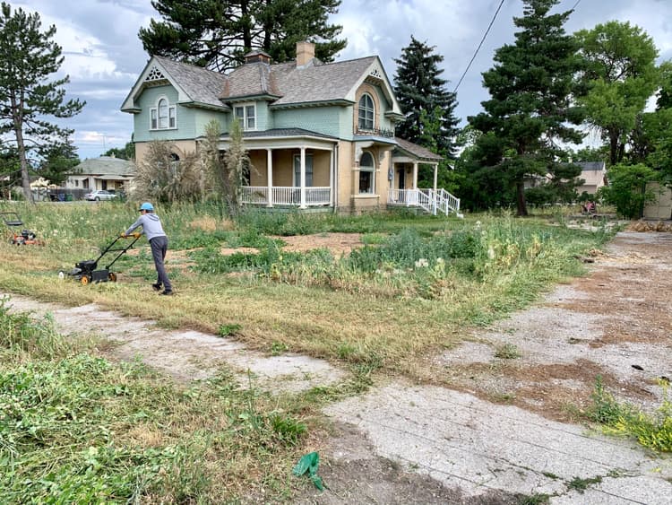A volunteer mowing the yard