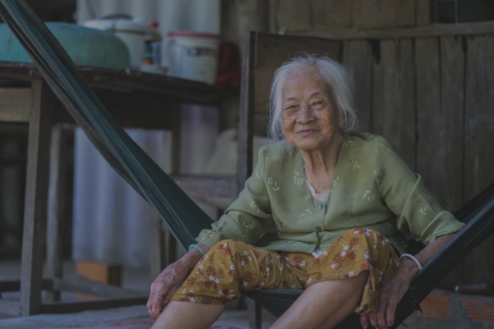 An elderly widow seated on her porch